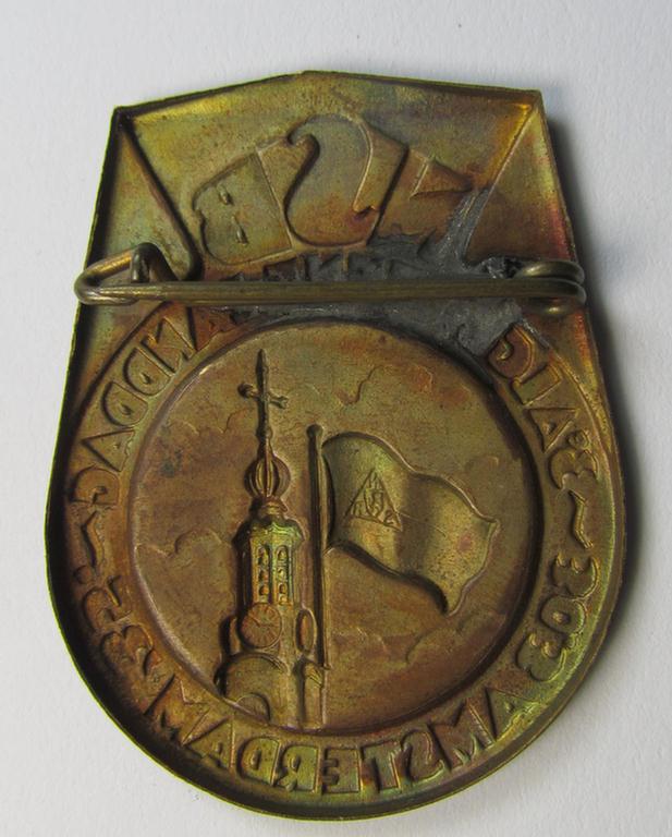 Dutch NSB-party-related: 'Landdag'-lapel-pin (ie. 'Veranstaltungsabzeichen' ie. tinnie) that is executed in golden-toned- (ie. copper-based-) metal and that is depicting the text: 'NSB - Algemene Landdag - Amsterdam - 30.3.35'