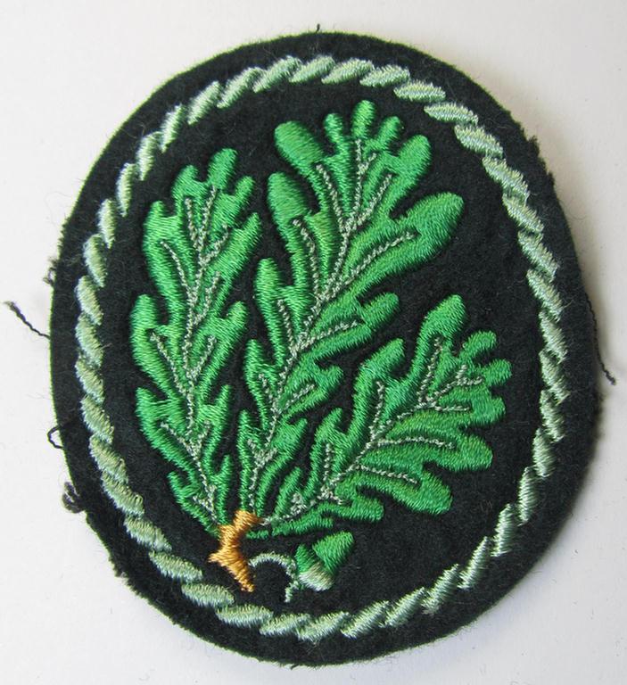 Attractive example of a WH (Heeres) so-called: 'Jäger'-armbadge, being a neatly machine-embroidered- and/or multi-coloured version as was executed on darker-green-coloured wool