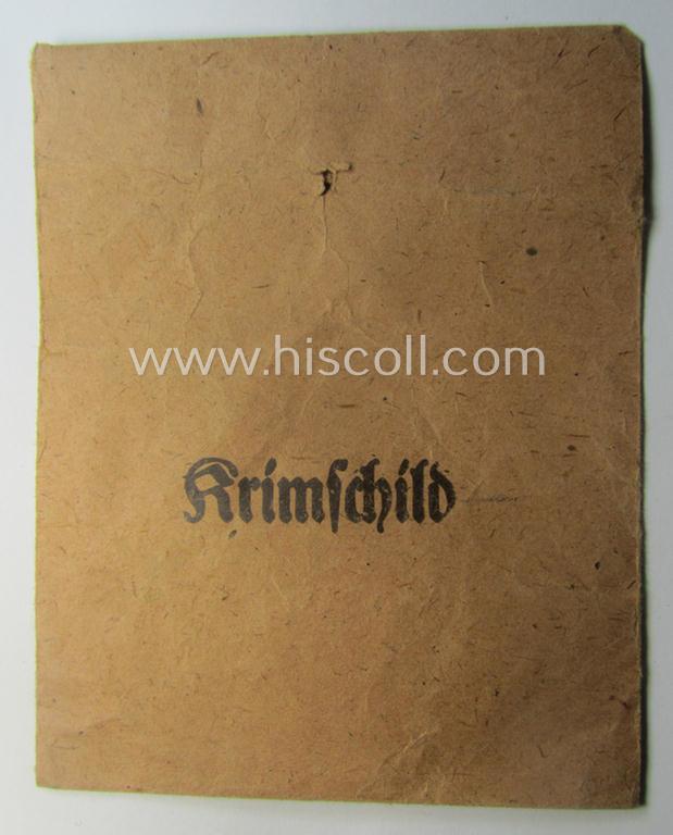WH (Heeres ie. Waffen-SS) 'Krim'-campaign-shield (by the maker: 'Friedrich Orth') that comes stored in its period (and rarely seen!) 'Zellstoff'-based pouch and that comes in a probably issued- (albeit still 'virtually mint'-), condition