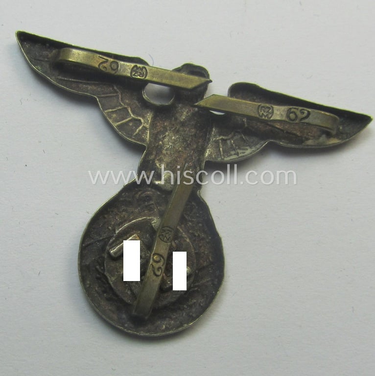 Silver-toned - and 'Buntmetall'-based - early-pattern, SS- o. SA-type, political visor- (ie. 'Schirmmützen'-) cap- (ie. 'Kepi'-) eagle being a (triple!) maker- (ie. 'RzM 62'-) marked example that comes in a used- ie. carefully cap-removed, condition