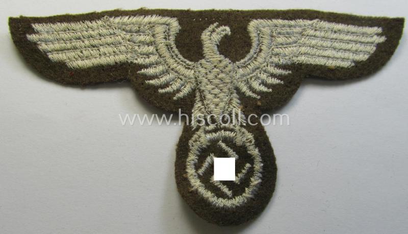 Attractive, machine-embroidered arm-eagle (ie. 'Ärmeladler') as was specifically intended for usage on the brownish-green-coloured tunics of officials of the: 'Reichsministerium für besetzte Ostgebiete' (ie. 'R.M.b.O.')