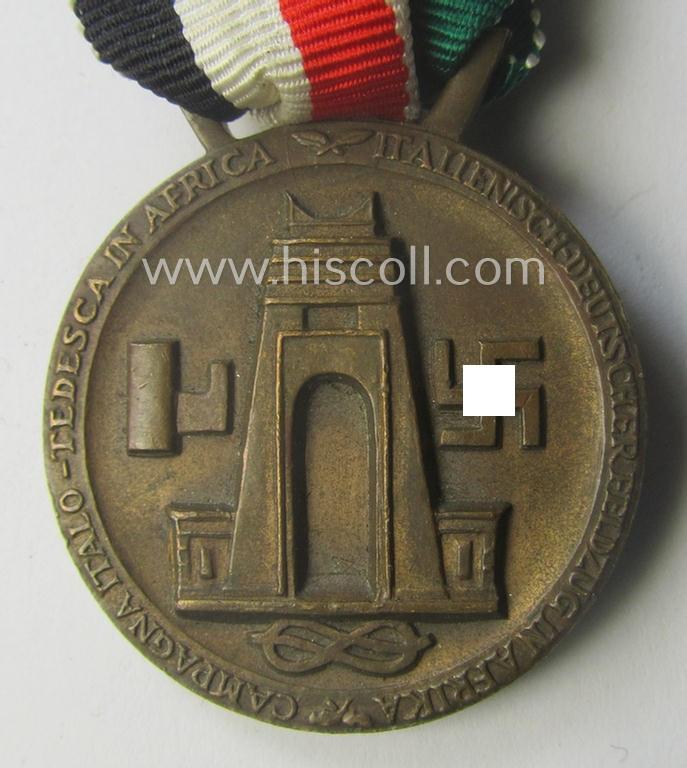 Golden-bronze-coloured (and 'Buntmetall'-based!) example of a: 'Deutsch-Italienische Feldzugsmedaille' (or: German-Italian campaign-medal) that came mounted onto its (full length- and 'virtually mint- ie. unissued') piece of original ribbon