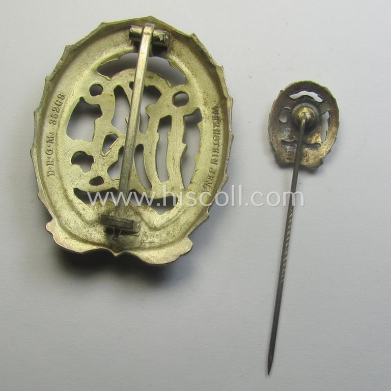 'Reichssportabzeichen DRL in Silber' (or: silver-class DRL sports'-badge) being a maker- (ie. 'Wernstein - Jena'-) marked example and that comes with its accompanying miniature