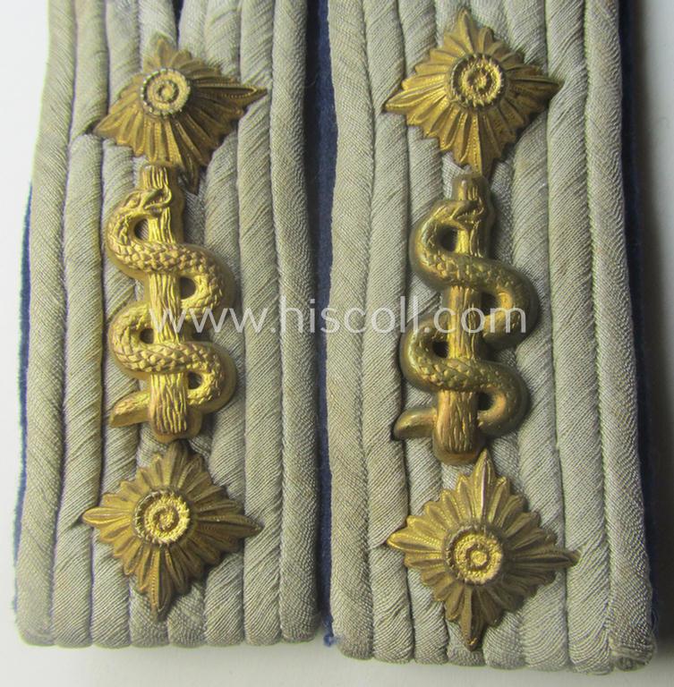 Pair of 'cyphered', WH (Heeres) officers'-pattern shoulderboards as piped in the darker-blue-toned branchcolour as was specifically intended for a: 'Hauptmann u. Arzt einer Sanitäts-Abtlgs.'