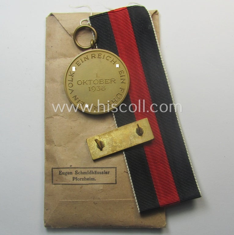 WH Czech-occupation- (ie. 'Anschluss'-) medal: '1. Oktober 1938' that comes with its accompaning 'PB-Spange' and that comes stored in its period pouch by the maker: 'Eugen Schmidhäussler - Pforzheim'