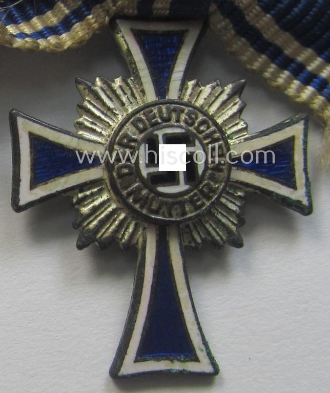 Miniature of an: 'Ehrenkreuz der deutschen Mutter - zweite Stufe' (or: silver-class mothers'-cross) being a non-maker-marked example that comes in an overall nice- (albeit moderately worn- ie. used-), condition