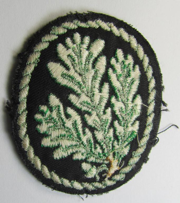 Attractive example of a WH (Heeres) so-called: 'Jäger'-armbadge being a neatly machine-embroidered- and/or multi-coloured version as was executed on darker-green-coloured wool