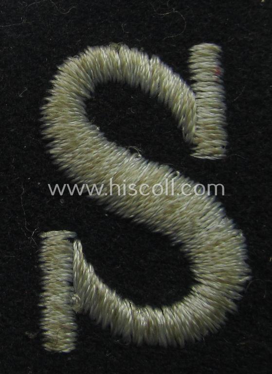 Waffen-SS-pattern, machine-embroidered and black-coloured sleeve-insignia (ie. 'Ärmelraute') depicting a captital: 'S'-character as was used to signify the function of: 'Schirrmeister' within the: 'Waffen-SS'