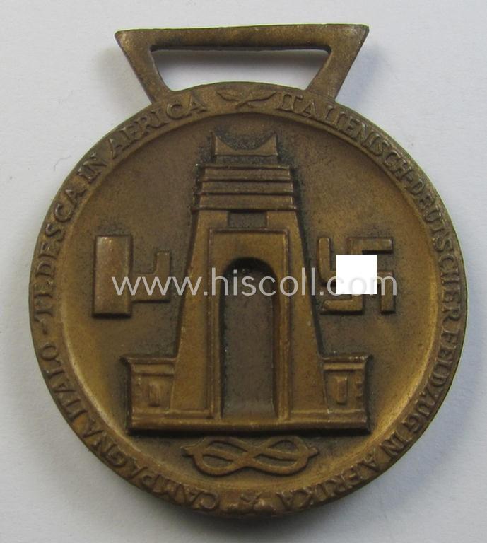 Superb, golden-bronze-coloured- (and I deem 'Buntmetall'-based-) example of a: 'Deutsch-Italienische Feldzugsmedaille' (or: German-Italian campaign medal) that came together with its (regular-sized) piece of original ribbon