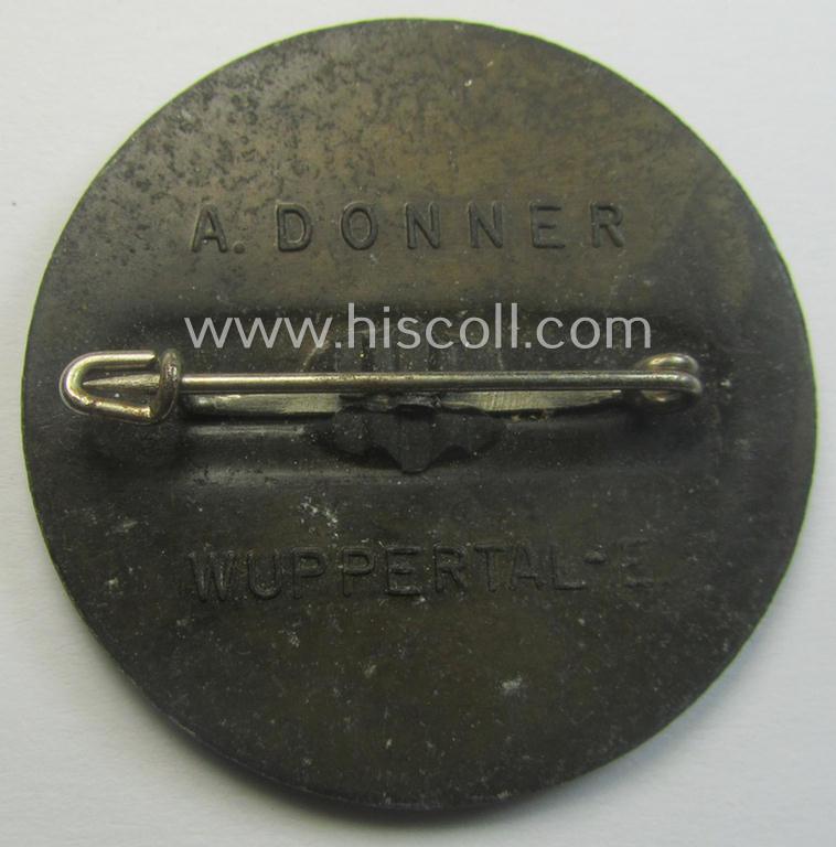 Commemorative, greyish-black-toned- and/or: typical zinc-based: 'N.S.K.O.V.'-related 'tinnie' being a maker- (ie. 'A. Donner'-) marked example showing the text: 'Reichstreffen der N.S.K.O.V. - Berlin - 1. Aug. 1937'