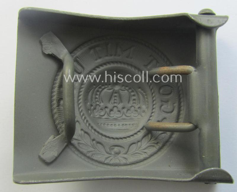 WWI-period field-grey-coloured- and/or steel-based belt-buckle being a (typical) non-maker-marked example that shows the motto: 'Gott mit Uns' and came still packed into its period piece of thin-shaped 'wrapping-paper'