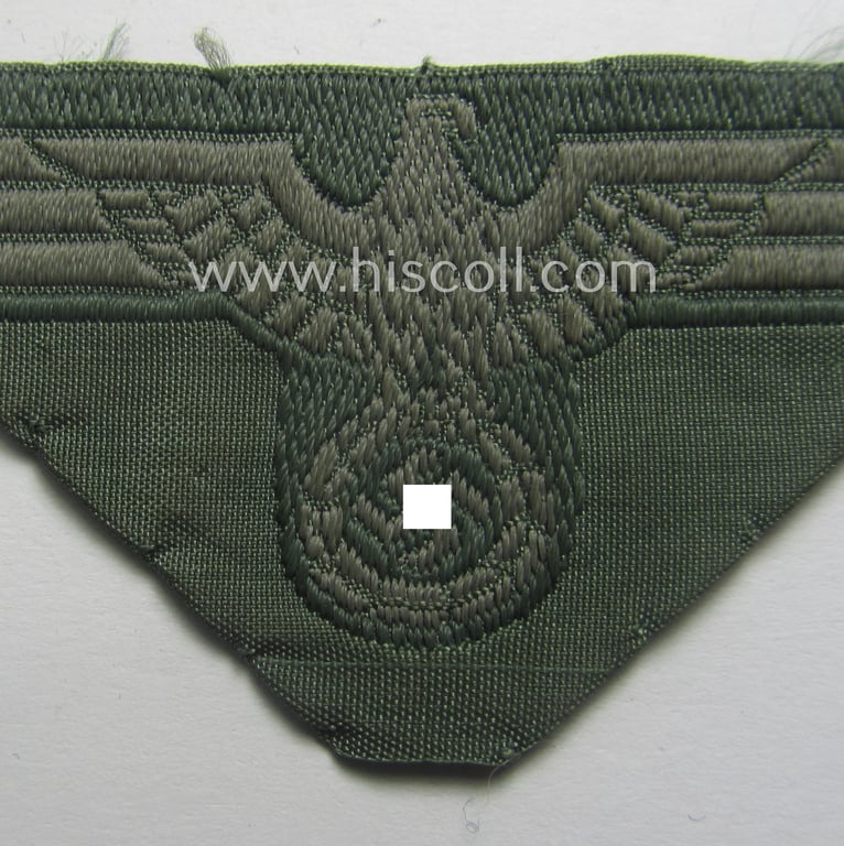 Truly used and cap-removed, early- (ie. mid-) war-period WH (Heeres) cap-eagle (ie. 'Schiffchenmützen-Adler für Mannschaften u. Uffz.') being a trapezoid-shaped example as executed in bluish-grey-coloured linnen on a field-grey-coloured background