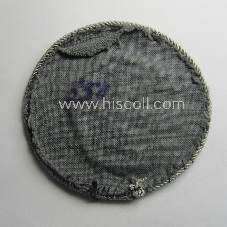 Superb - and actually rarely encountered! - example of a WH (Luftwaffe) neatly hand-embroidered, trade- ie. special-career-patch (ie. 'Tätigkeitsabzeichen') having a silverish-grey-toned 'Kordel' attached as was intended for: 'LW-Kraftfahrperson...