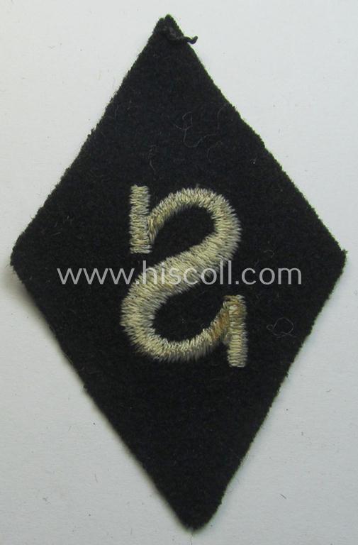 Waffen-SS-pattern, machine-embroidered and black-coloured sleeve-insignia (ie. 'Ärmelraute') depicting a captital: 'S'-character as was used to signify the function of: 'Schirrmeister' within the: 'Waffen-SS'