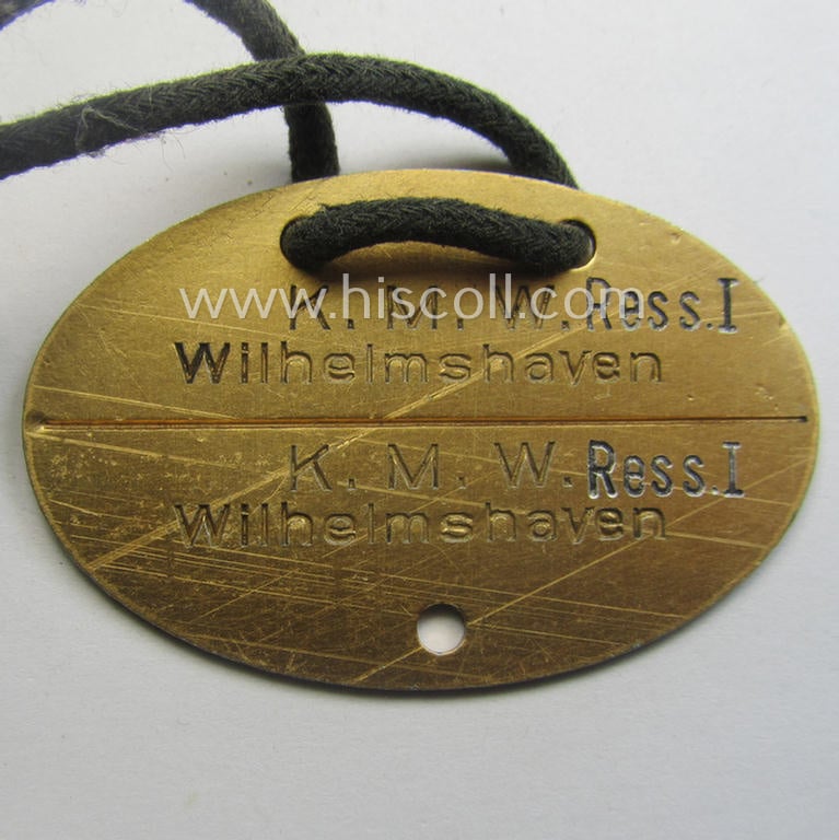 'Standard-issue'-pattern, WH (KM) typical aluminium-based- and/or bright golden-toned ID-disc (ie. 'Erkennungsmarke'): 'K.M.W. Ress. I - Wihelmshaven -  Heinen - 2895 - 79' and accompanying 'Bootsmanns-Flöte'
