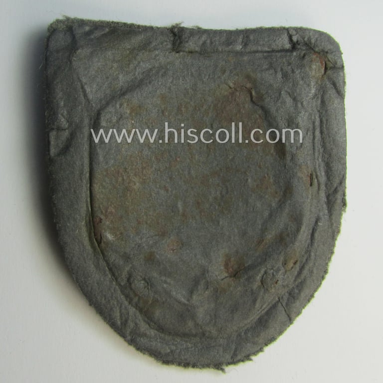 Attractive - truly worn and actually scarcely encountered! - WH (Heeres ie. Waffen-SS) 'Kuban'-campaign-shield that comes mounted onto its original field-grey-coloured- and/or woolen-based 'backing' as issued and/or used
