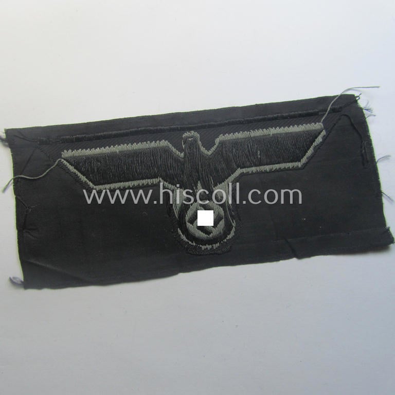 Later- (ie. mid-war-) period, WH (Heeres) 'Panzer'-type breast-eagle (ie. 'Brustadler für Panzertruppen') being a 'virtually mint- ie. unissued' example as executed in bluish-grey-coloured linnen on a black-coloured background