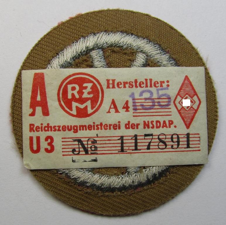 Neat example of a HJ ('Hitlerjugend') 'Motor-HJ Prüfungsabzeichen' (or: motor-proficiency badge)  being an example of the silver-class that still retains  its period-attached 'RzM'-etiket