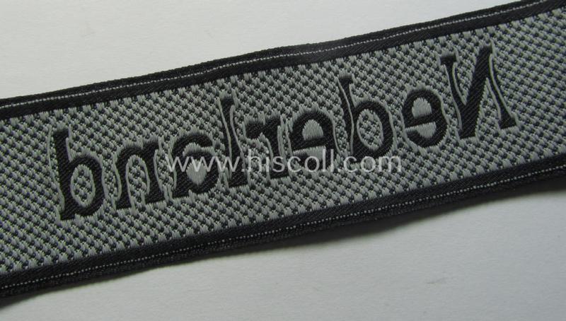 Superb, Waffen-SS, 1943/44 pattern cuff-title (ie. 'Ärmelstreifen') depicting the machine-woven Latin script text in silver-grey linnen as was intended for a member serving within the: '23. SS Freiwilligen Panzer Grenadier Division' ('Nederland...