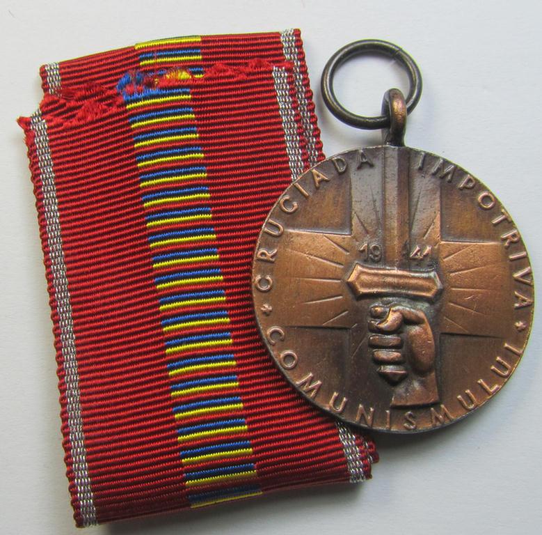 Romanian medal: 'Kreuzzug gegen den Kommunismus' (or in Romanian language: 'Medalia - Crusiada Impotriva Communismului') that comes together with its original (and never confectioned- ie. 'virtually mint') ribbon as issued