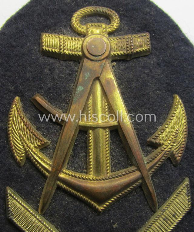 Attractive - and actually scarcely encountered! - WH (Kriegsmarine) golden-toned, so-called: career- ie. specialist-armbadge (ie. 'Dienstgrad-Abzeichen') as was specifically intended for usage by an: 'Oberzimmermannsmaat' (ie. senior naval-carpen...