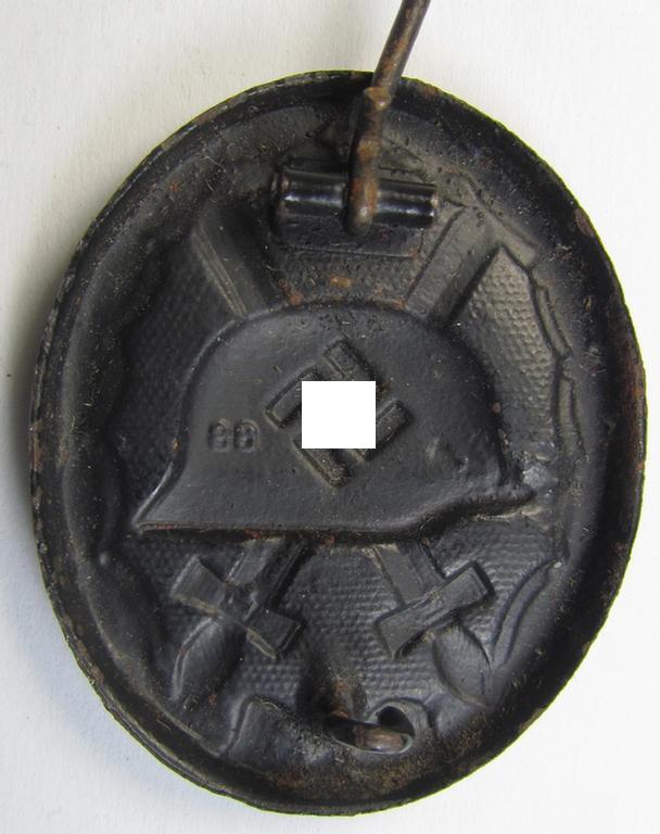 Moderately used and neatly maker- (ie. '88'-) marked example of a black-class wound-badge (or: 'Verwundeten-Abzeichen in Schwarz') being an example that was produced by the desirable maker (ie. 'Hersteller') named: 'Werner Redo'