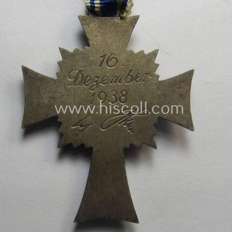 'Ehrenkreuz der deutschen Mutter - zweite Stufe' (or: silver-class mothers'-cross) that came mounted onto its long-sized ribbon and that came stored in its period pouch by the maker: 'Gottlieb & Wagner - Oberstein/Nahe'