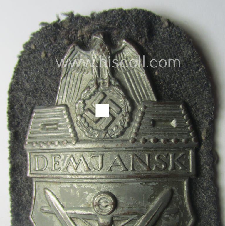 WH (Luftwaffe) 'Demjansk'-campaign-shield as executed in typical magnetic metal (ie. so-called: 'Eisenblech') and that comes in an overall nice- (ie. most certainly worn but nevertheless ie. fully untouched!), condition