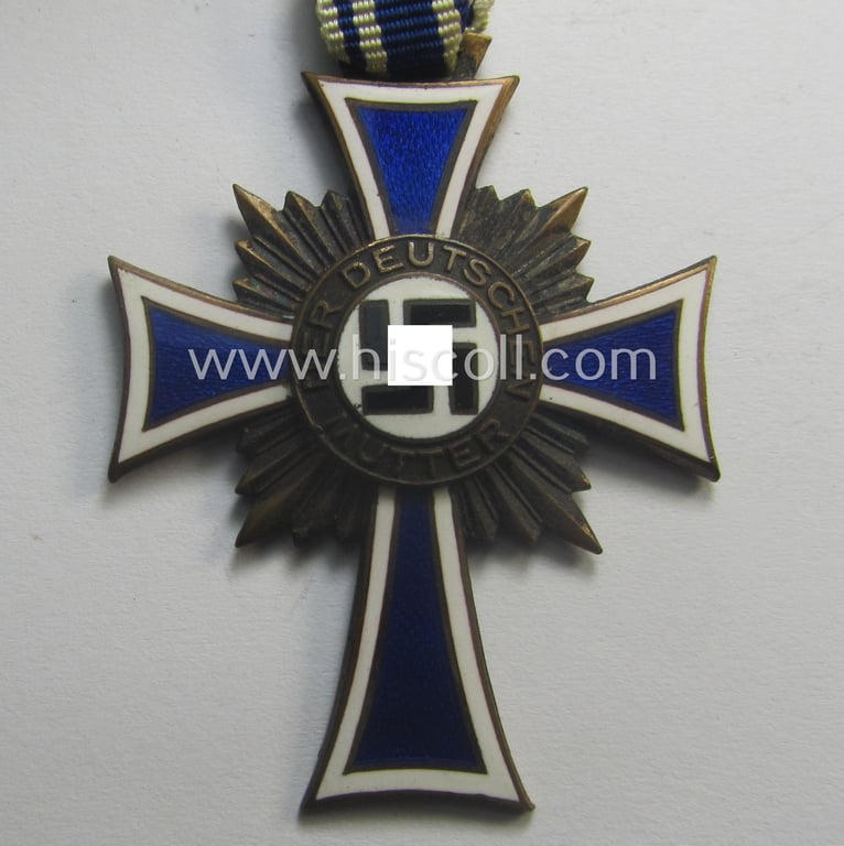 'Ehrenkreuz der deutschen Mutter - dritte Stufe' (or: bronze-class mothers'-cross) that came mounted onto its long-sized ribbon and that came stored in its period pouch by the maker: 'Louis Gottlieb - Oberstein a.d. Nahe'