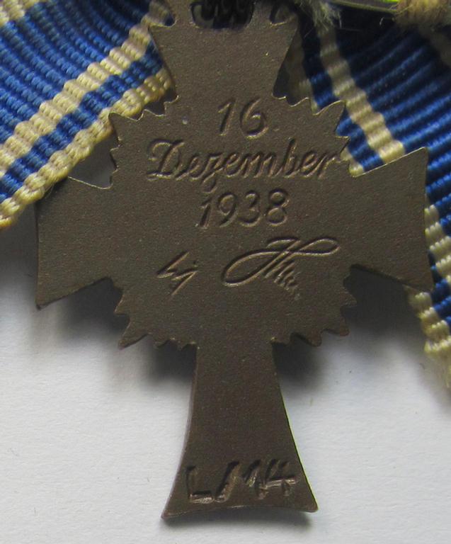 Miniature of an: 'Ehrenkreuz der deutschen Mutter - dritte Stufe' (or: bronze-class mothers'-cross) being a maker- (ie. 'L/14'-) marked example that comes in an overall nice- (albeit moderately worn- ie. used-), condition