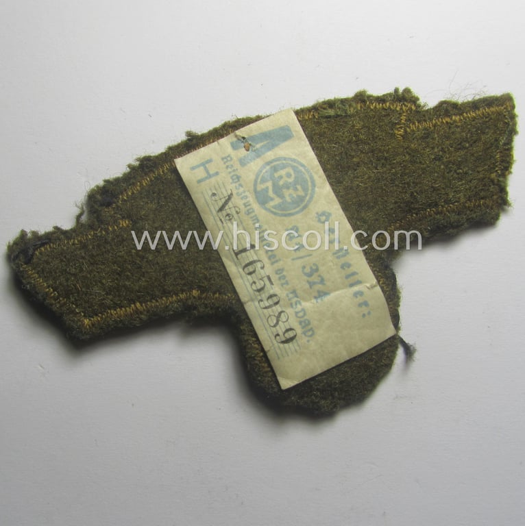 N.S.K.K. (ie. 'National Socialistisches Kraftfahr Korps') arm-eagle as executed in so-called: 'flat-wire', 'BeVo'-weave pattern and comes mounted onto a earthen-green-coloured (and/or woolen-based) 'backing' (and that still retains its 'RzM'-etiket)