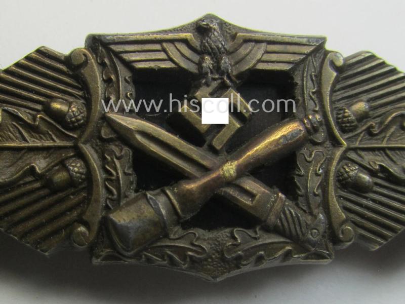 'Nahkampfspange in Bronze' (or: bronze-class close-combat clasp ie. CCC) being a maker- (ie. 'A.G.M.u.K.'-) marked- and/or minimal converse-shaped specimen having its period-attached (black-toned and steel-based) 'back-plate' in place