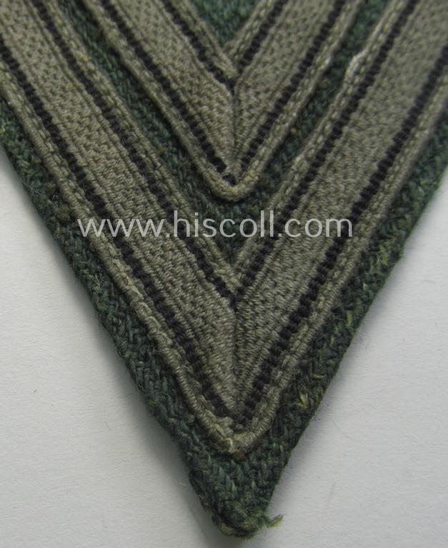 WH (Heeres ie. Waffen-SS) 'Armwinkel' (or: arm-chevron) as was executed on a greenish-coloured- and/or 'HBT'-like (ie. 'Drillich'-) based background as was specifically intended for an: 'Obergefreiter' (ie. 'SS-Rottenführer')