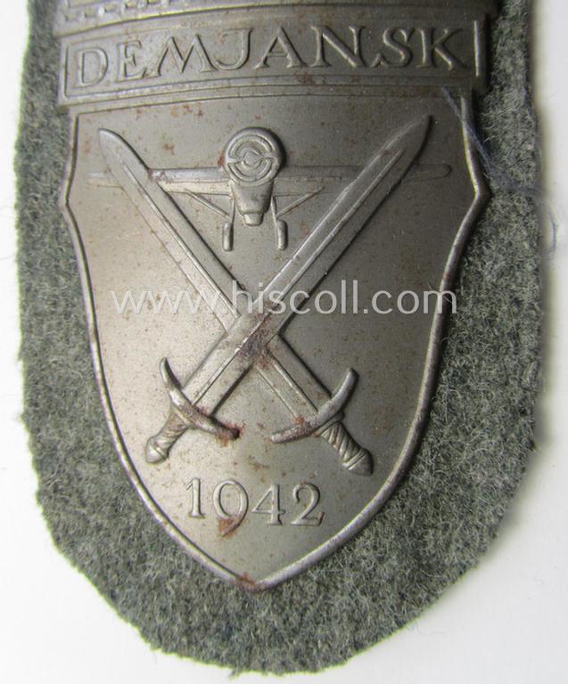 Superb - and fairly scarcely encountered! - example of a WH (Heeres ie. Waffen-SS) 'Demjansk'-campaign-shield as executed in typical magnetic metal (ie. so-called: 'Eisenblech') and that comes in an overall very nice- ie. fully untouched, conditi...