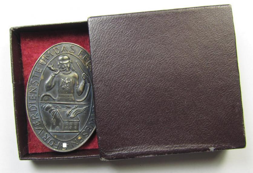 Pre-war-period- and/or silver-based (ie. '900'-stamped), so-called: 'Erinnerungszeichen Verdienste um das Feuerlöschwesen 1934' being a very detailed- and maker- (ie. 'Preuss. Staatsmünze'-) marked, example that comes stored in its period etui