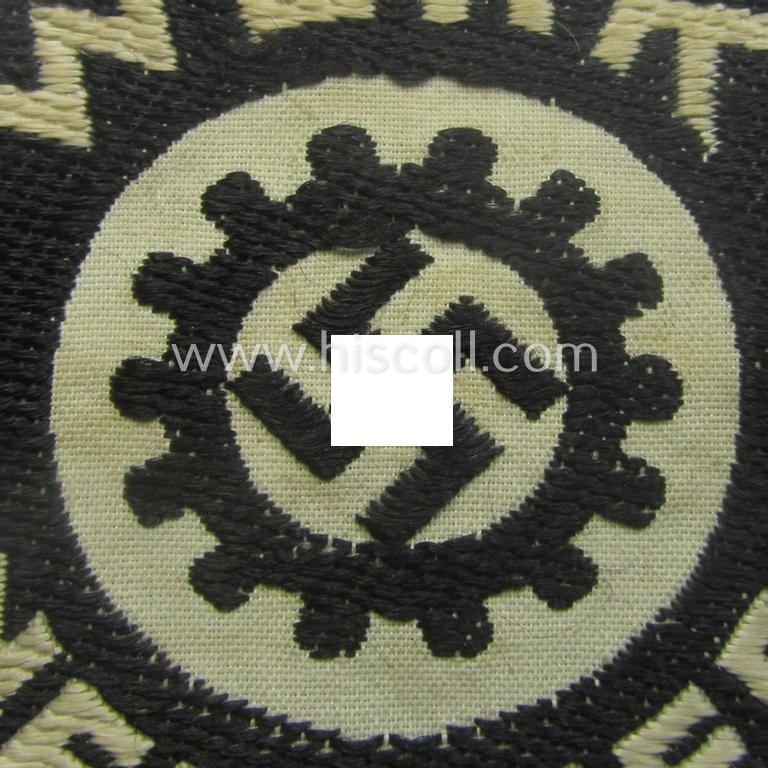 Unusual - and actually never before seen! - 'DAF' (ie. 'Deutsches Arbeitsfront o. Werkschar'-) related breast-badge as executed in 'BeVo'-weave pattern that shows the interwoven DAF 'Zahnrad'-symbol and text: 'Werk Neuwied'