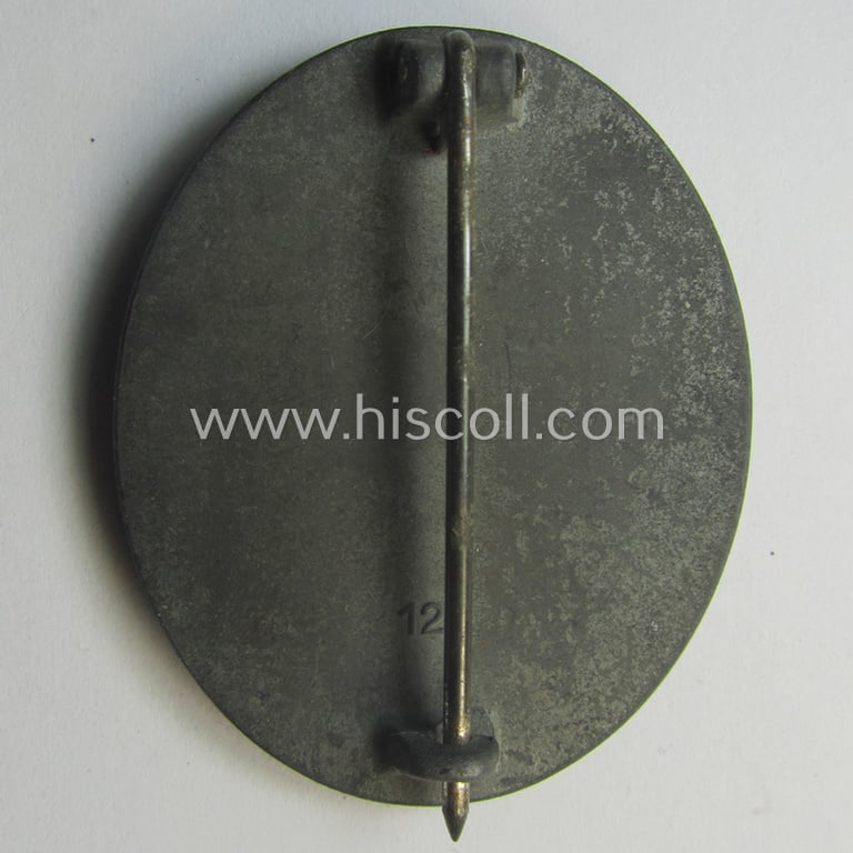 Unusual, silver-class wound-badge (or: 'Verwundeten-Abzeichen in Siber') being a maker- (ie. '127'-) marked example that comes stored in its original (damaged), carton-based pouch by the maker (ie. 'Hersteller'): 'Moriz Hausch A.-G.'