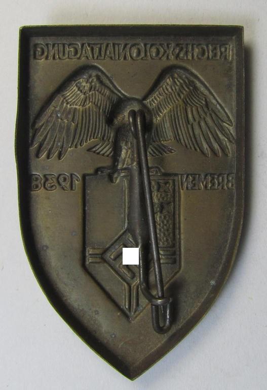 Commemorative, copper-based- (ie. 'NS-Reichskolonial-Bund'-related-) 'tinnie', being a non-maker-marked example depicting an 'eagle'-device above the 'NS-Reichskolonial-Bund'-device and showing the text: 'Reichskolonialtagung - Bremen - 1938...