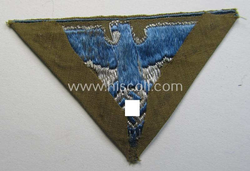 Attractive, SA-related cap-eagle as was intended for the: 'Lagermütze' (ie. side-cap) being an example as woven on a bright-blue-coloured background and as such intended for members within the: 'SA-Gruppe Warthe o. Oberrhein'