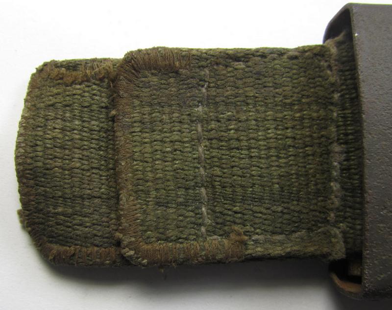 Neat, WH (Heeres) 'tropical-issued' belt-buckle (being a non-maker-marked and/or typical olive-green-coloured) example that comes mounted onto its original, greenish-coloured (and/or: 'webbing'-based-) tab