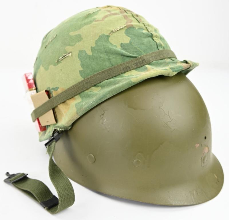US Vietnam War Infantry helmet with camouflage cover and attached content