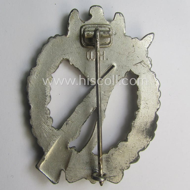 'Infanterie Sturmabzeichen in Silber' being a maker- (ie. 'W.H.'-) marked and/or quite converse, 'solid-back' example by the Austrian-based maker: 'Wilhelm Hobacher' as was executed in bright silver-coloured, zinc-based metal