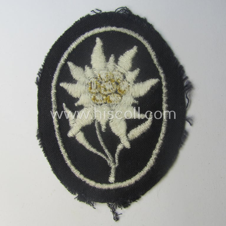 Waffen-SS-pattern, black-coloured sleeve-insignia (ie. 'Ärmelabzeichen') depicting an: 'Edelweiss'-flower as used by the various 'Gebirgsjäger'- (ie. mountain-troops-) related divisional-staff