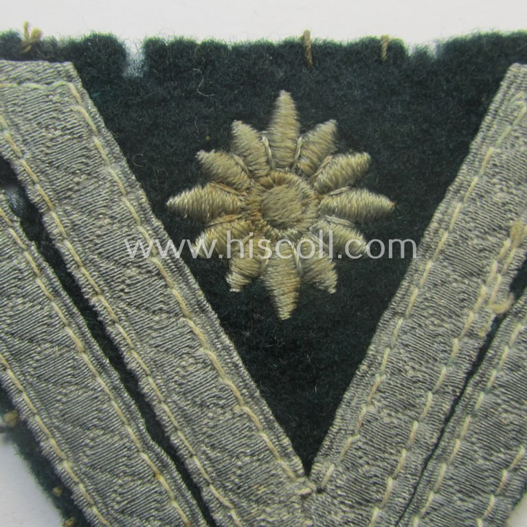 WH (Heeres) 'Armwinkel' (or: arm-chevron) as executed on typical darker-green-coloured wool as was specifically intended for usage by a soldier with the (unusually encountered!) rank of: 'Stabsgefreiter'
