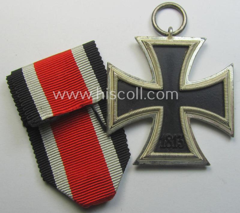 'Eisernes Kreuz II. Klasse' being a maker- (ie. '113'-) marked example that comes together with its original- (and once-mounted) ribbon (ie. 'Bandabschnitt') by the maker (ie. 'Hersteller'): 'Hermann Aurich'