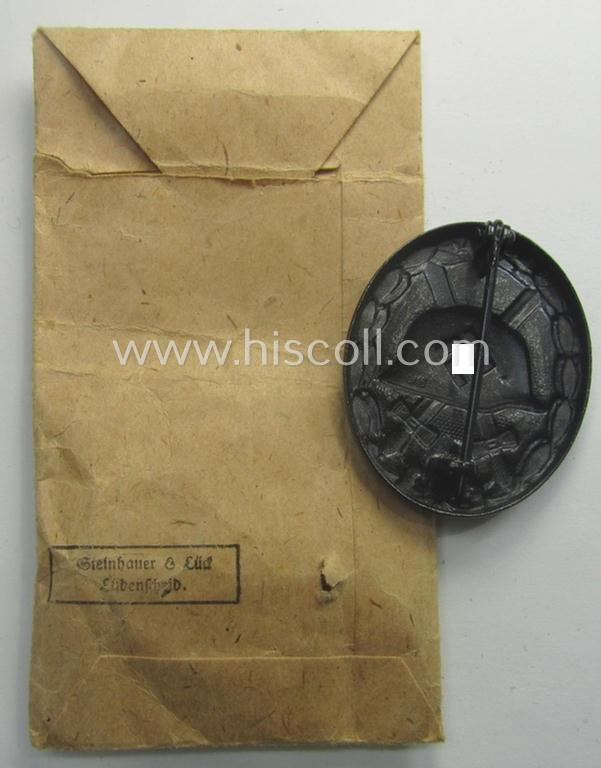 'Verwundeten-Abzeichen in Schwarz' being a maker- (ie. 'L/16'-) marked example by the: 'Steinhauer & Lück'-company that came stored in its (scarcely seen!) period pouch