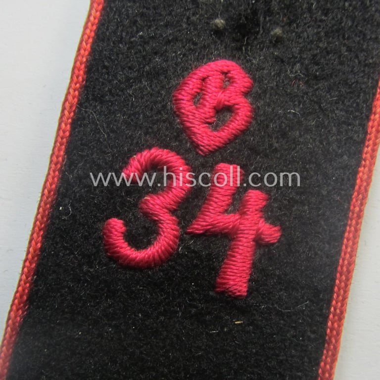 Superb - single but nevertheless rarely found! - crimson-red-piped and neatly 'cyphered': 'Allgemeine' HJ ('Hitlerjugend') shoulderstrap as was intended for - and worn by! - an: 'Oberscharführer' being a designated staff-member for the district '34'