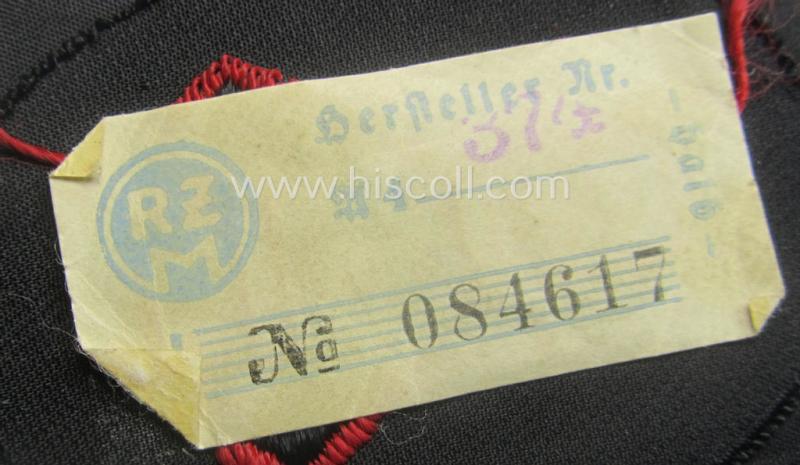 N.S.K.K.- (ie. 'National-Socialistisches Kraftfahr-Korps'-) related armbadge as was intended for an: 'N.S.K.K.-Sanitäts-Unterführer o. Mann' (ie. 'Feldscher') that still retains its 'RzM'-etiket