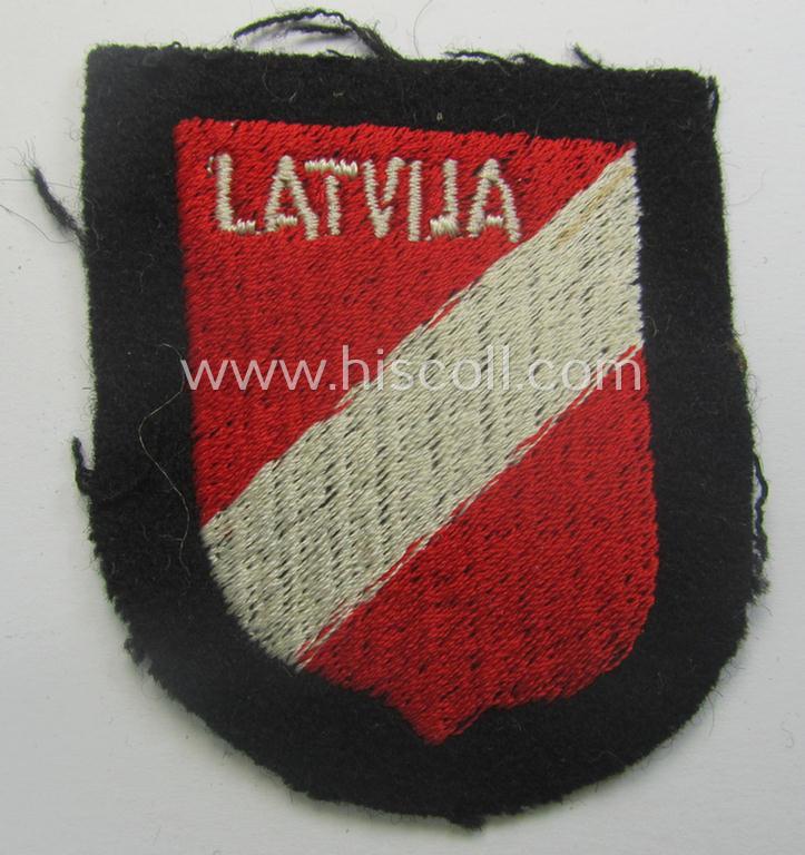 Latvian, Waffen-SS 'volunteer' arm-shield as was specifically intended for usage by soldiers of the: '15. o. 19. Waffen-Grenadier-Division der SS' (ie. 'lettische nr. 1 o. 2') that comes in a 'virtually mint- ie. unissued', condition