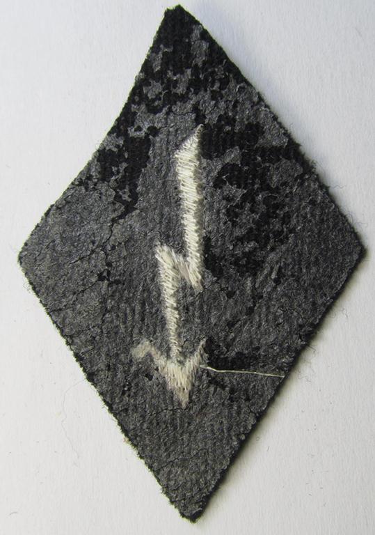 Neat, Waffen-SS-pattern-, machine-embroidered and black-coloured sleeve-insignia (ie. 'Ärmelraute') depicting a so-called: 'Signalblitz', as was used and intended to signify membership within a: 'Waffen-SS Nachrichten'-unit
